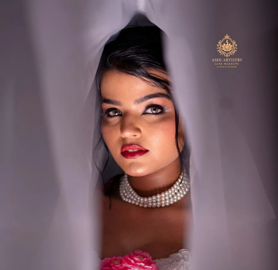 Studio portrait with a pearl choker on a warm backdrop