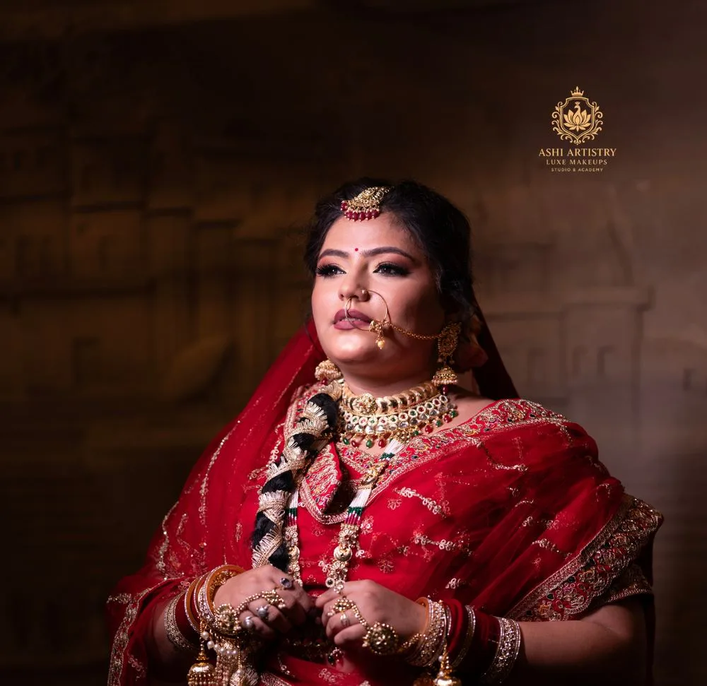 Bridal portrait in a red kundan-jewelled lehenga at a heritage haveli